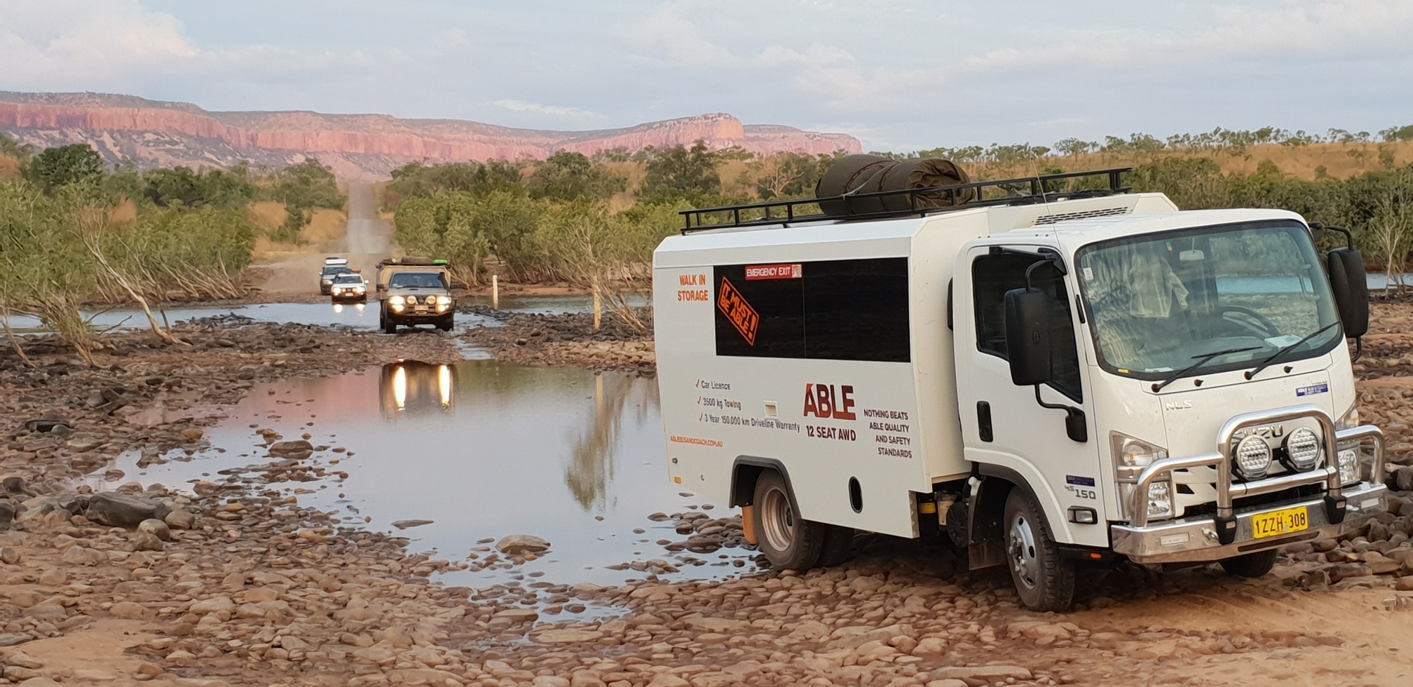 Isuzu NLS AWD bus crossing a remote Kimberley river